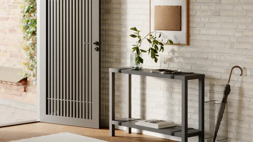 Rendered Dragonfly Industrial Entry Table in black wood with metal straps, standing against a white brick wall in an entryway