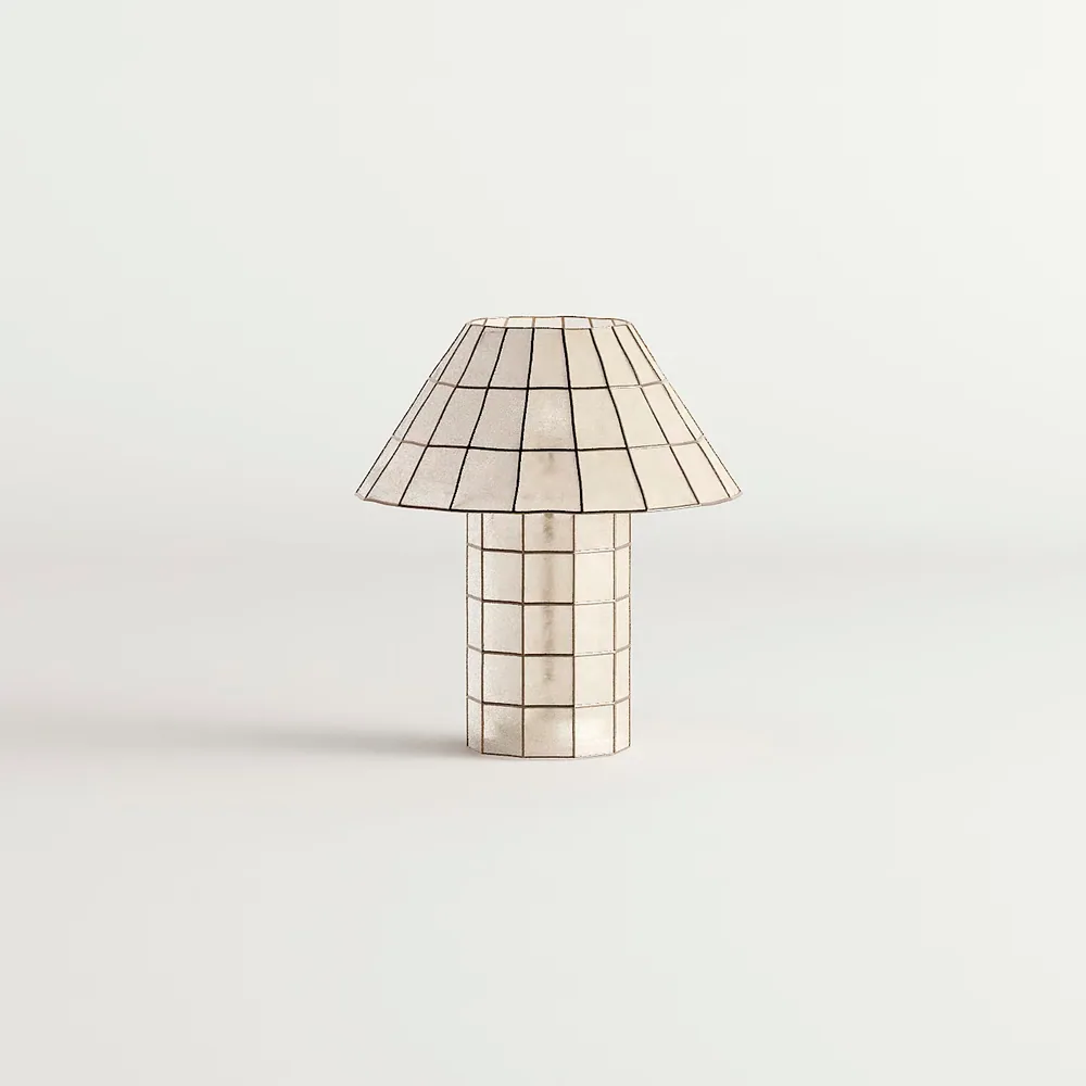 A table lamp with a gridded shade, shown switched off